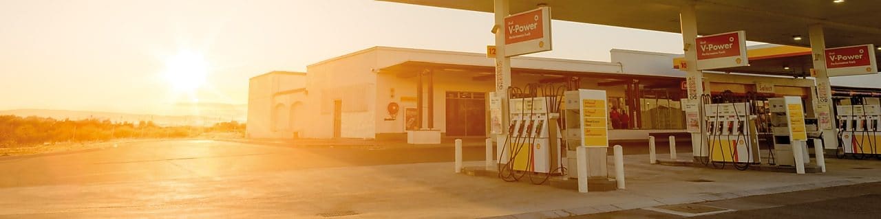 The forecourt of a shell service station at dusk